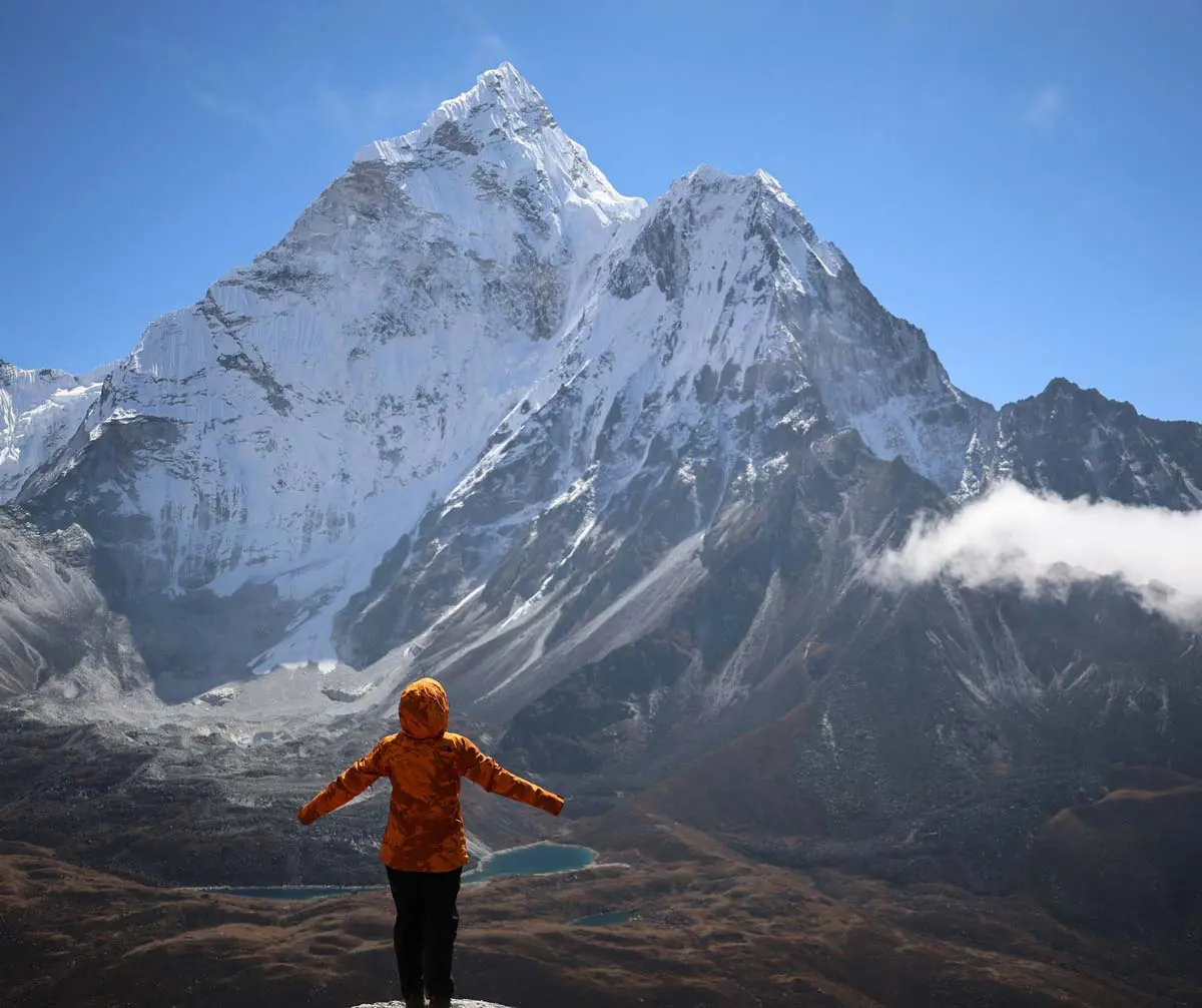 A trekker standing in front of Mt. Amadablam during acclimatization hike to Nangkartsang peak